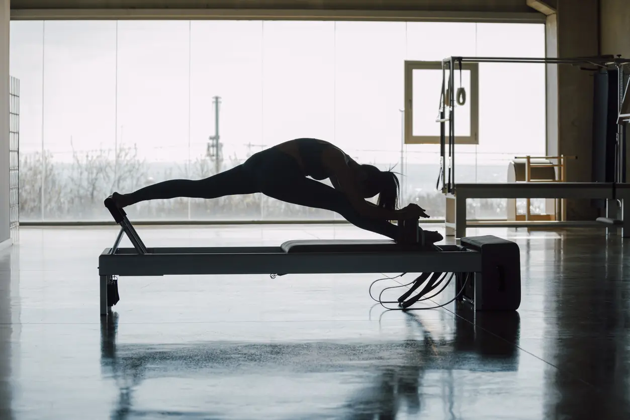 A person is doing yoga on a bench